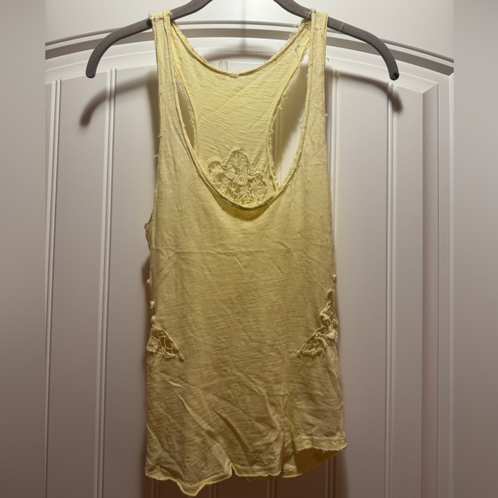 Yellow Free People tank top with lace details on the back